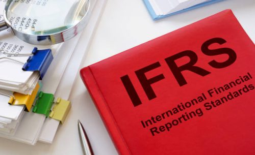 a stack of papers and book ifrs international financial reporting standards.